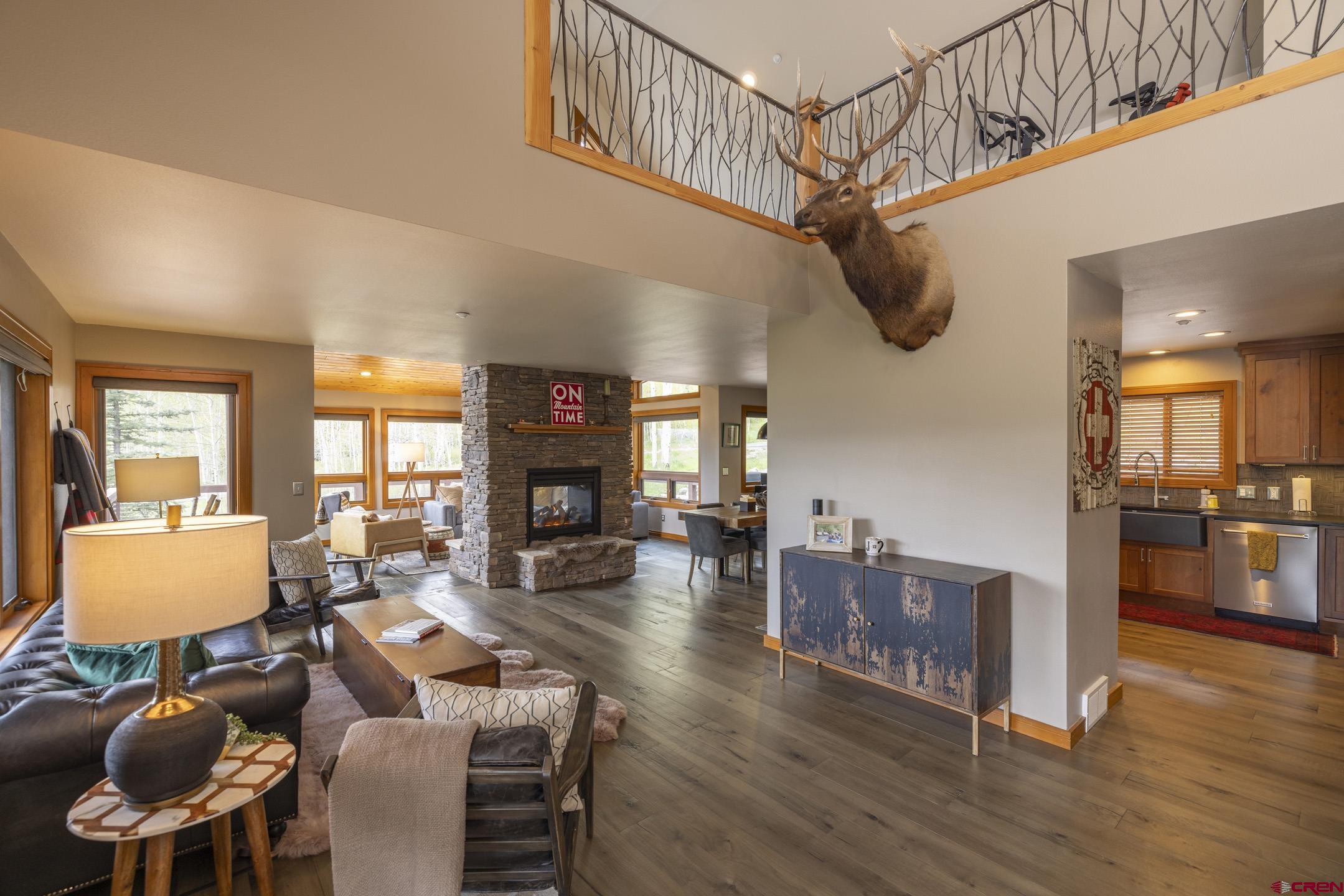 154 Falcon Ridge Road Durango, CO 81301 - Photo 6 of 42 a living room with furniture and a wooden floor