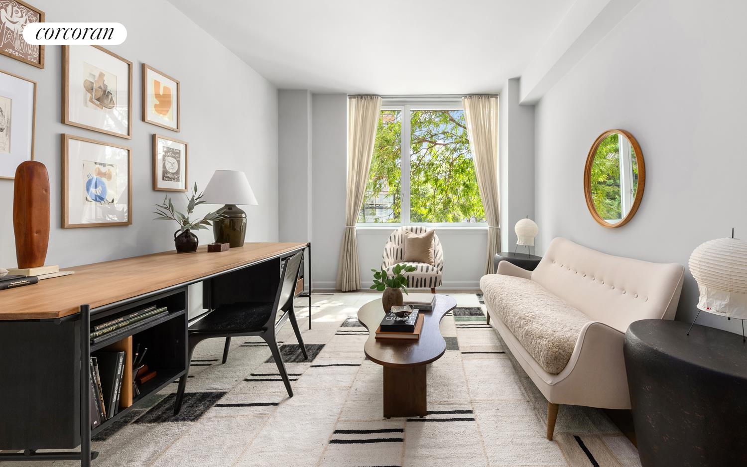 20 River Terrace, Unit 9M Manhattan, NY 10282 - Photo 8 of 11 a living room with furniture a rug and a window