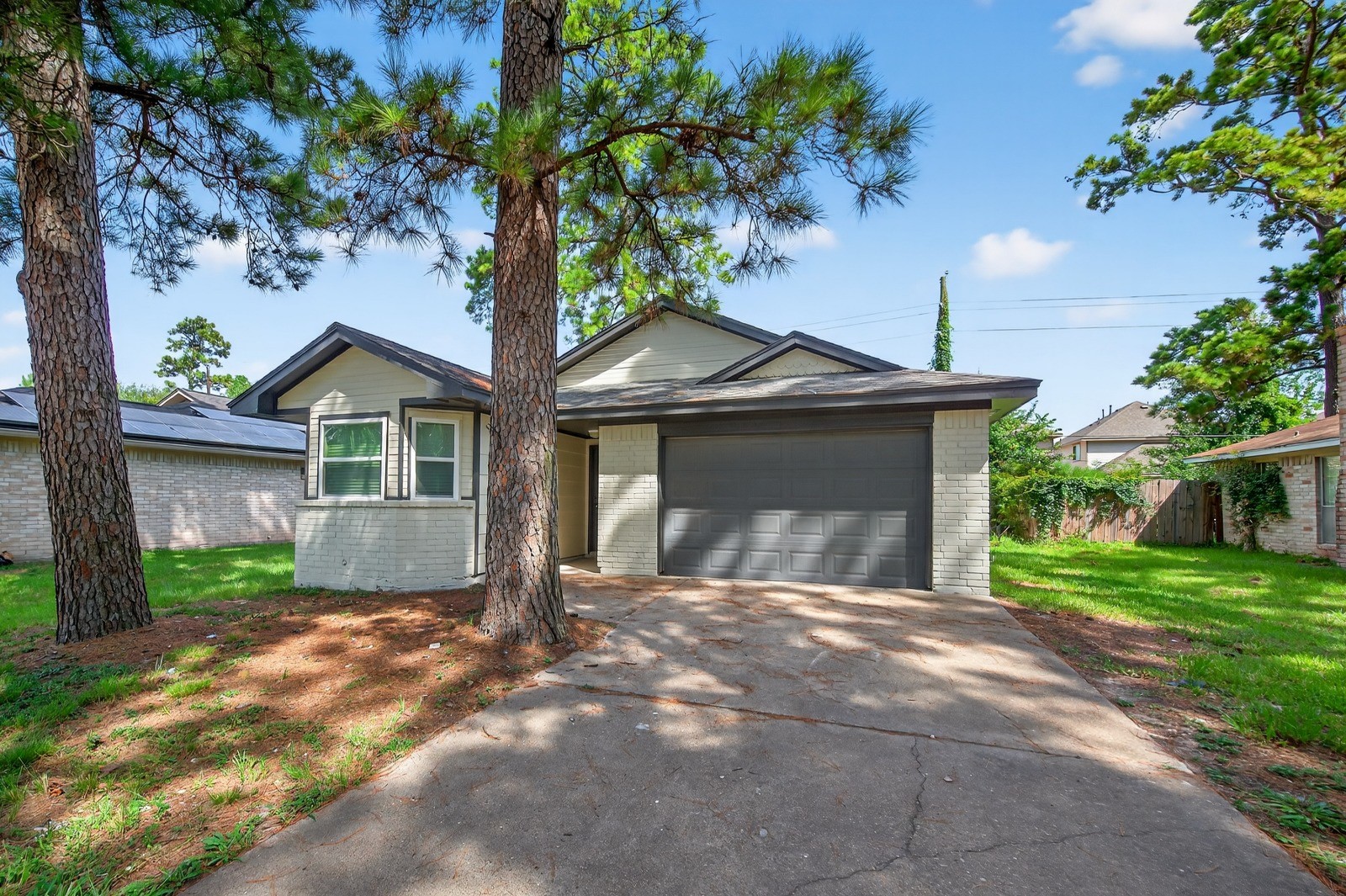 4911 Maurita Drive Spring, TX 77373 - Photo 1 of 15 a front view of a house with a yard and garage