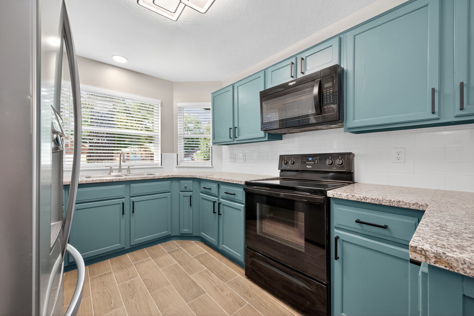 4911 Maurita Drive Spring, TX 77373 - Photo 6 of 15 a kitchen with granite countertop cabinets stainless steel appliances and a sink