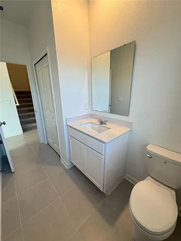 a bathroom with a sink a toilet and mirror