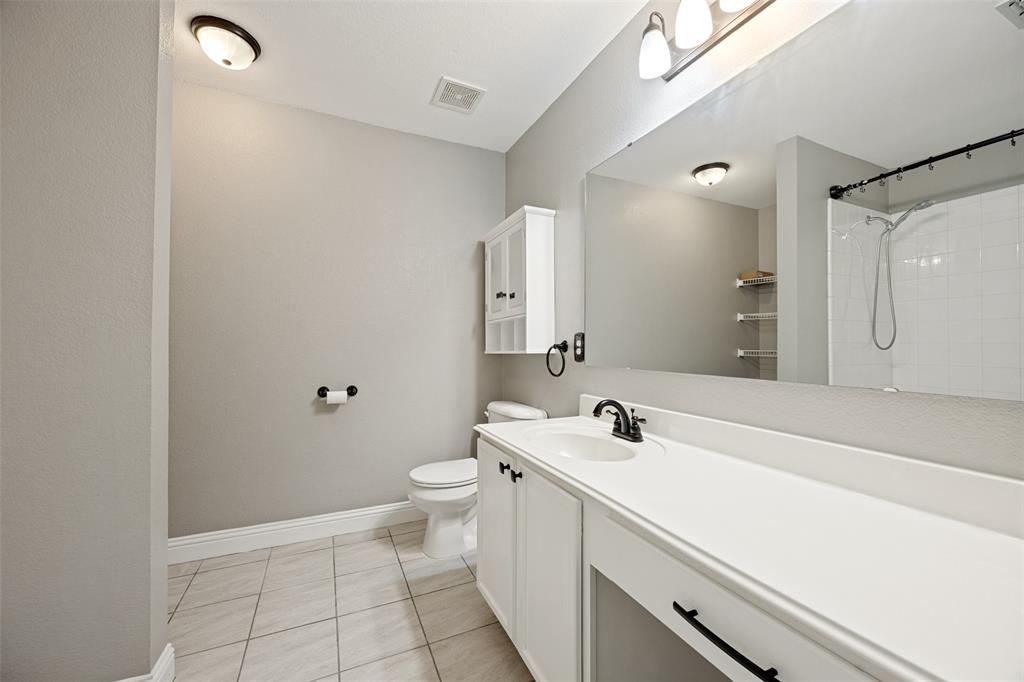 1601 Elm Street Anna, TX 75409 - Photo 15 of 25 a bathroom with a sink a toilet and shower