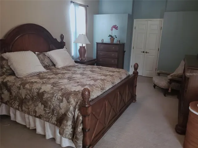 a bedroom with bed and cabinets