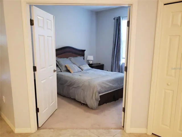 a bedroom with a bed and a mirror
