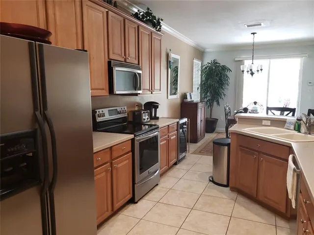 a kitchen with a sink stove and refrigerator