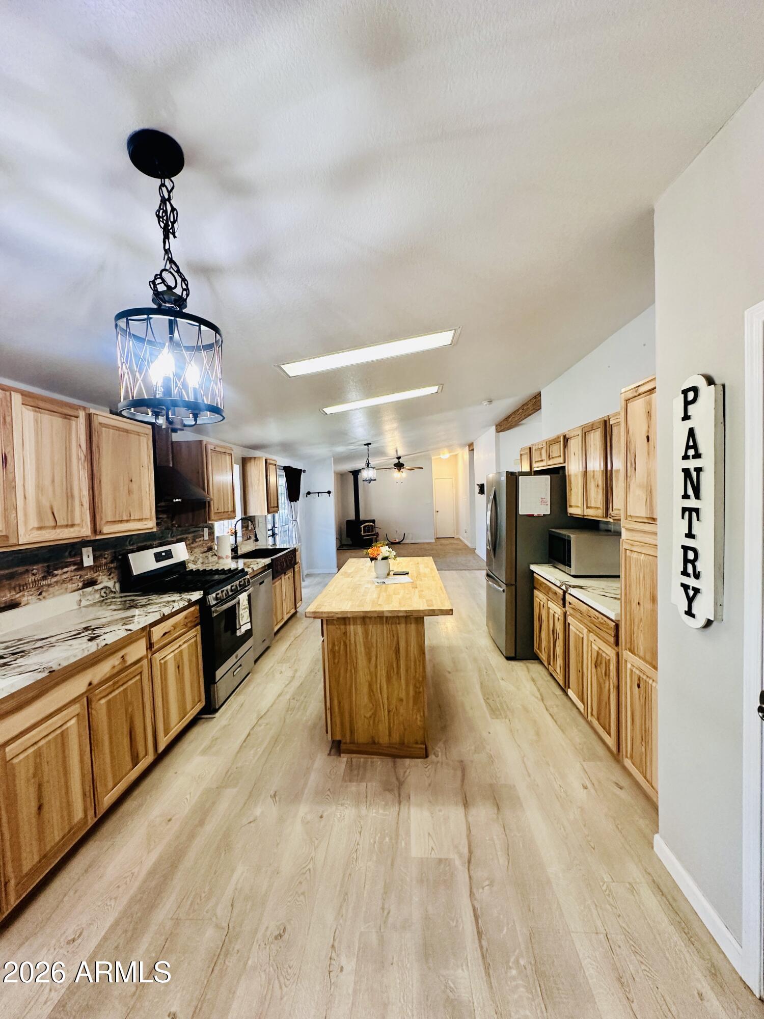 80 Acr 8050 Road Concho, AZ 85924 - Photo 2 of 32 a large kitchen with stainless steel appliances kitchen island granite countertop a large counter top cabinets and stainless steel appliances