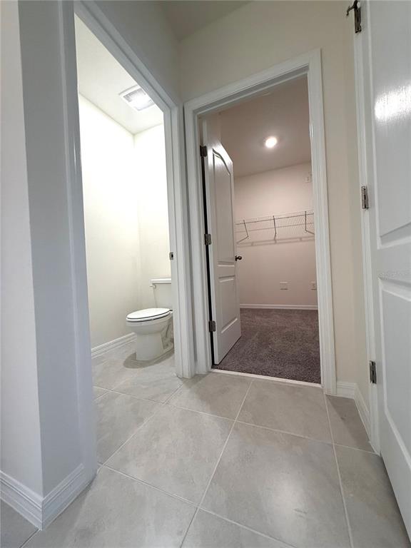 216 Taylor Groves St Lake Lake Wales, FL 33898 - Photo 14 of 18 a bathroom with a sink a toilet and a large mirror