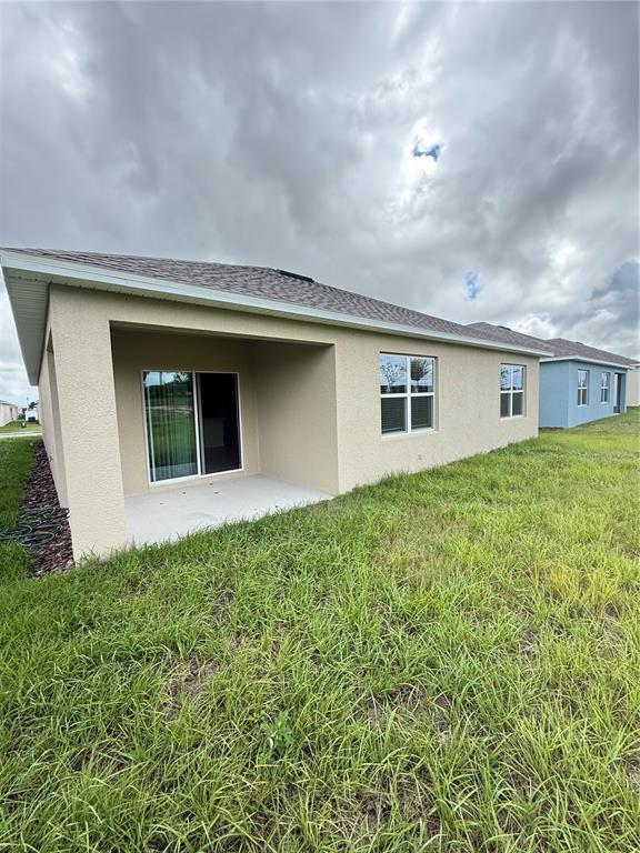 216 Taylor Groves St Lake Lake Wales, FL 33898 - Photo 17 of 18 a house view with a garden space
