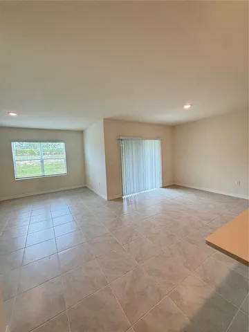 an empty room with a empty space and windows