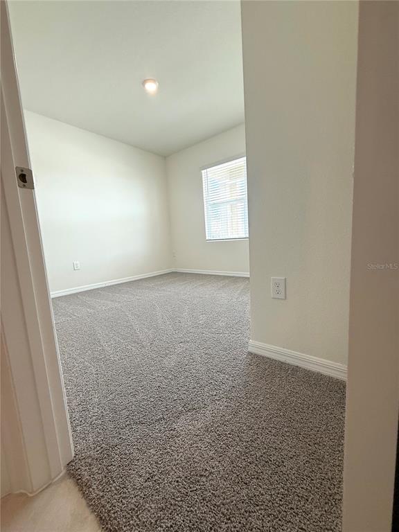 216 Taylor Groves St Lake Lake Wales, FL 33898 - Photo 5 of 18 an empty room with windows