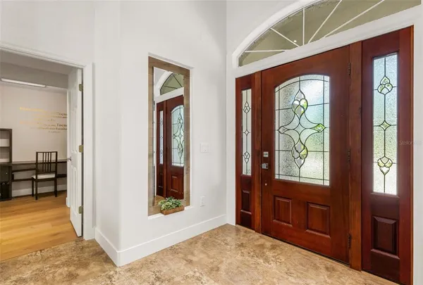 a kitchen with stainless steel appliances granite countertop a refrigerator a sink a stove a dining table and chairs
