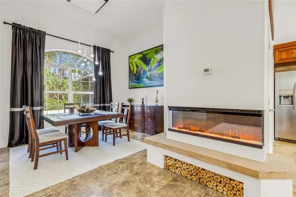 a kitchen with a sink and chairs