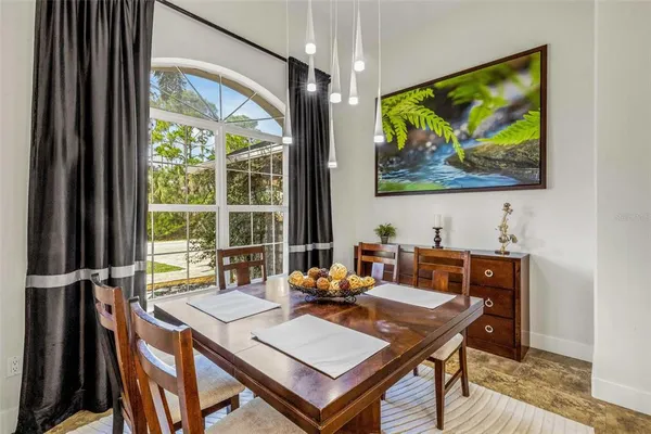 a view of a dining room with furniture and a chandelier