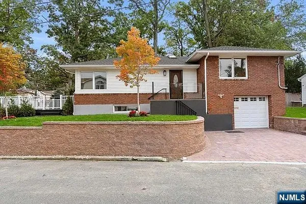 a front view of a house with a yard and a garage