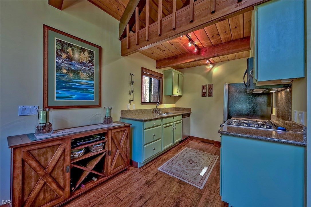 973 Apollo Way Incline Village, NV 89451 - Photo 12 of 35 a kitchen with stainless steel appliances granite countertop a stove a sink and a microwave