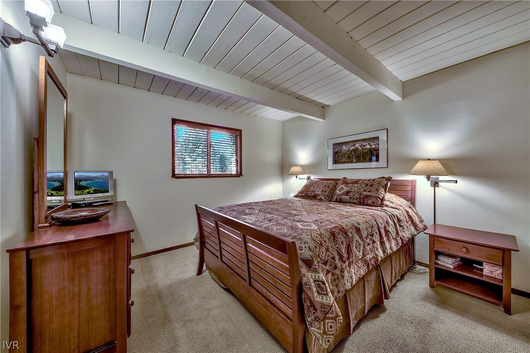 973 Apollo Way Incline Village, NV 89451 - Photo 20 of 35 a bedroom with a bed and a flat tv screen on a dresser