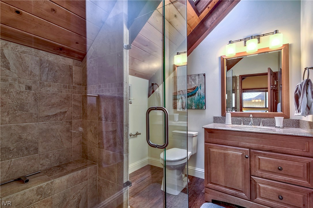 973 Apollo Way Incline Village, NV 89451 - Photo 23 of 35 a bathroom with a granite countertop toilet a sink and mirror