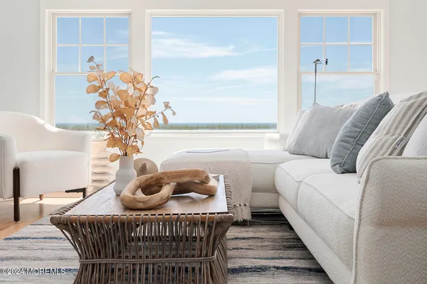 a view of a livingroom with furniture and hardwood floor