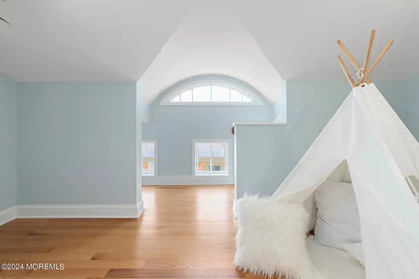 a view of a hallway with wooden floor and entryway