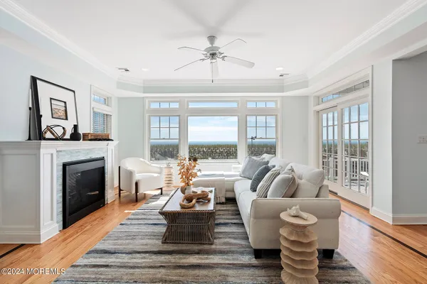 a living room with furniture and a floor to ceiling window