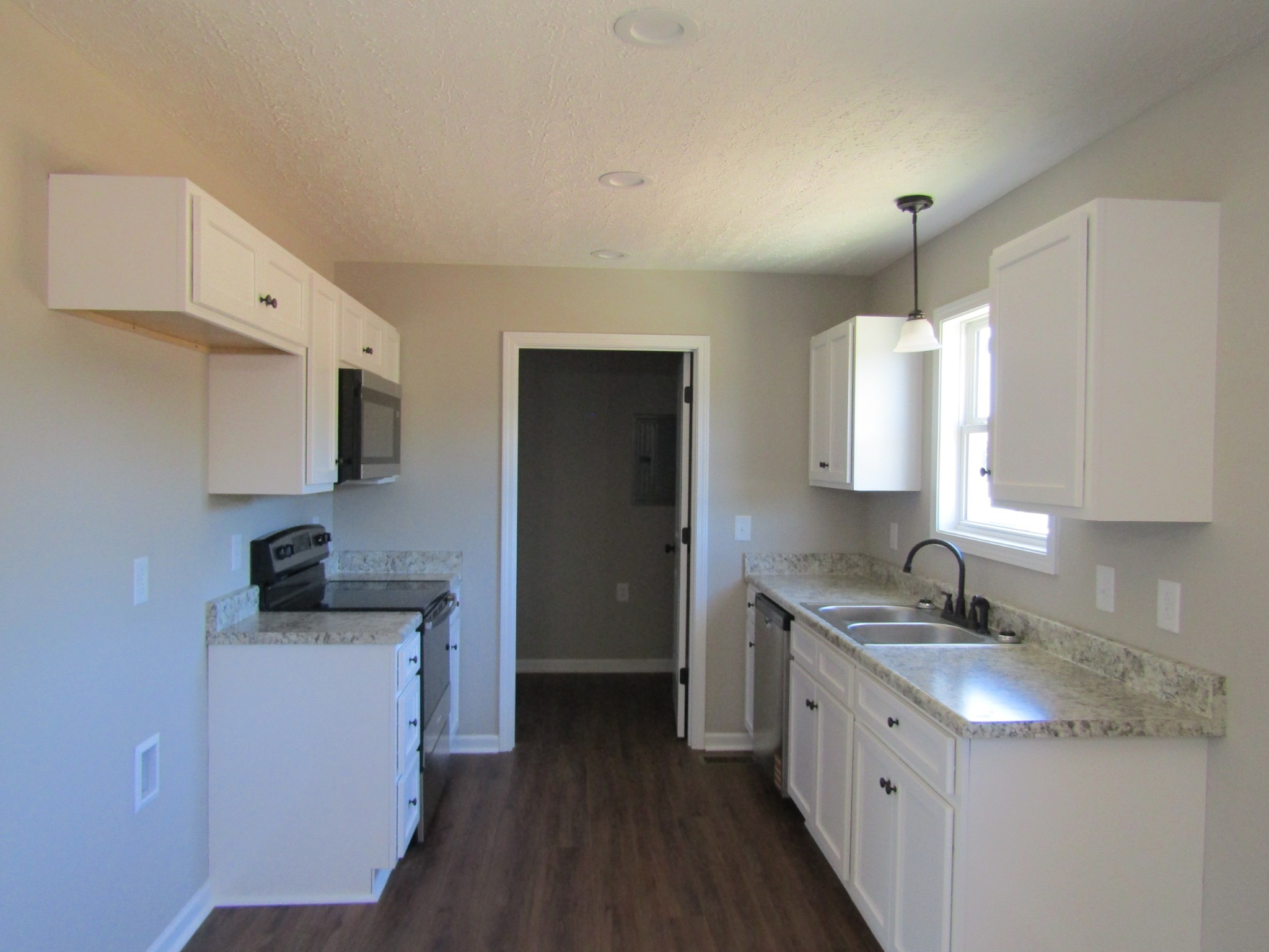 460 Crescent Factory Road Lawrenceburg, TN 38464 - Photo 5 of 13 a kitchen with a sink stove and refrigerator