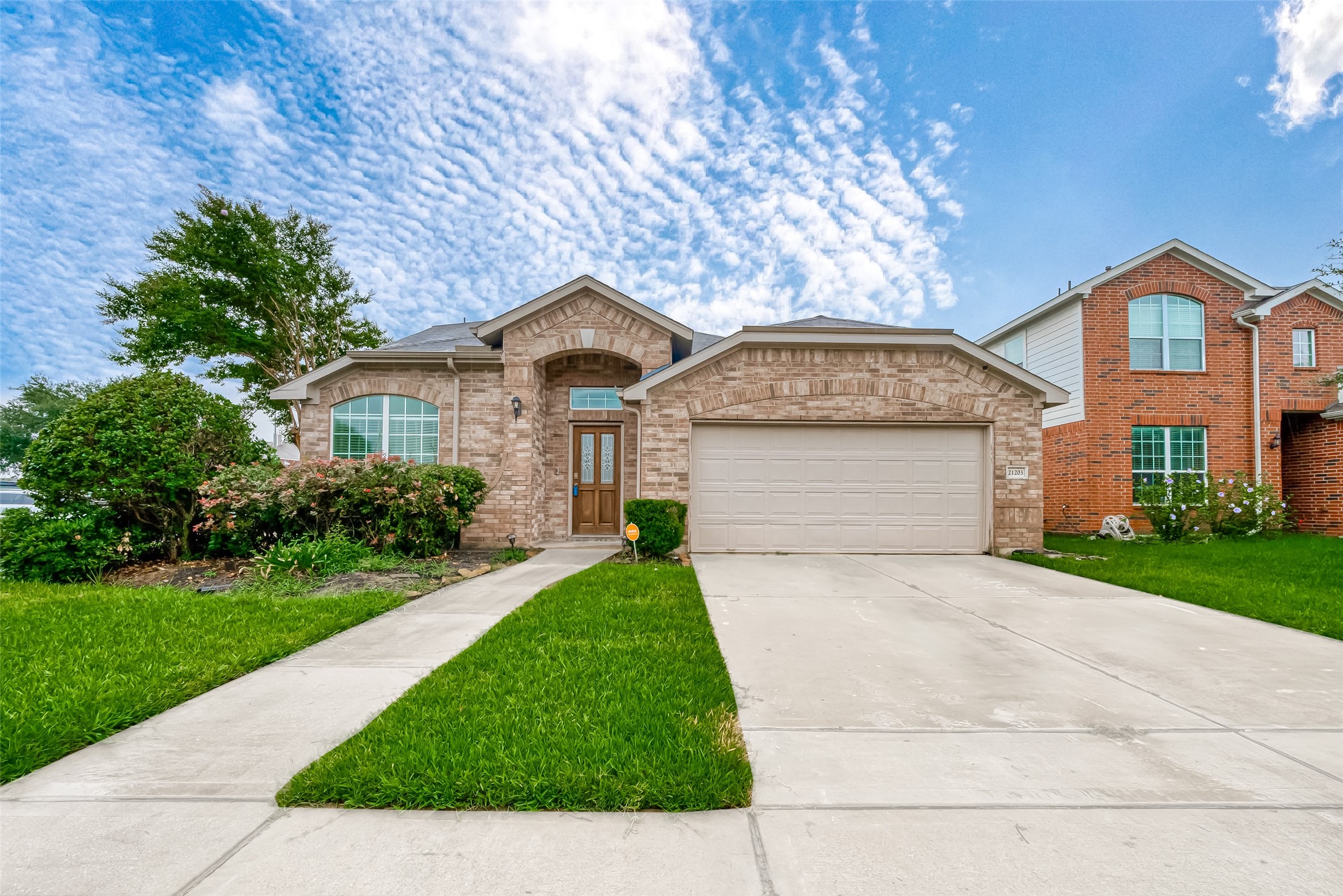 21203 Branchport Drive Houston, TX 77095 - Photo 1 of 49 a front view of a house with a yard