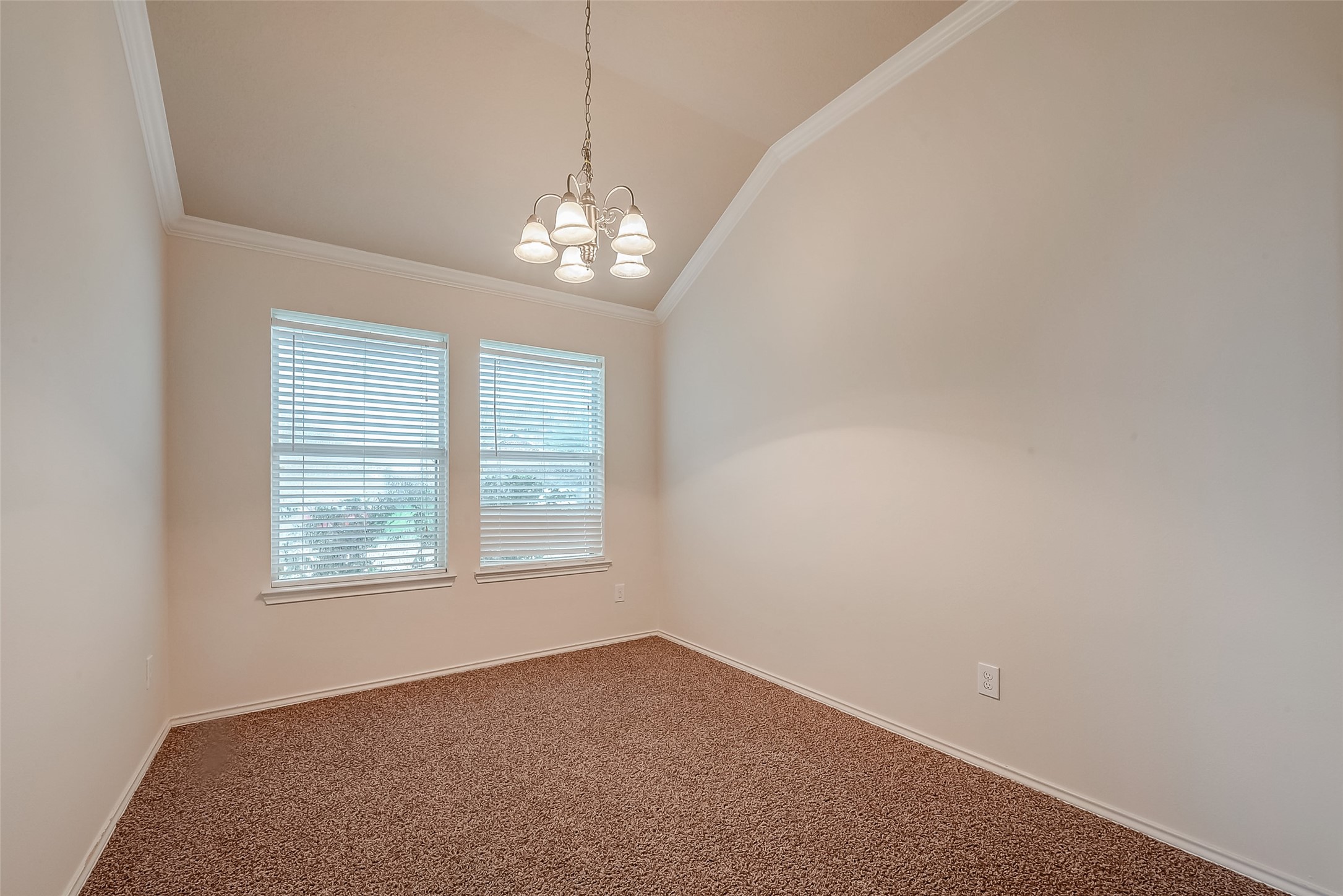 21203 Branchport Drive Houston, TX 77095 - Photo 12 of 49 en empty room with windows and chandelier