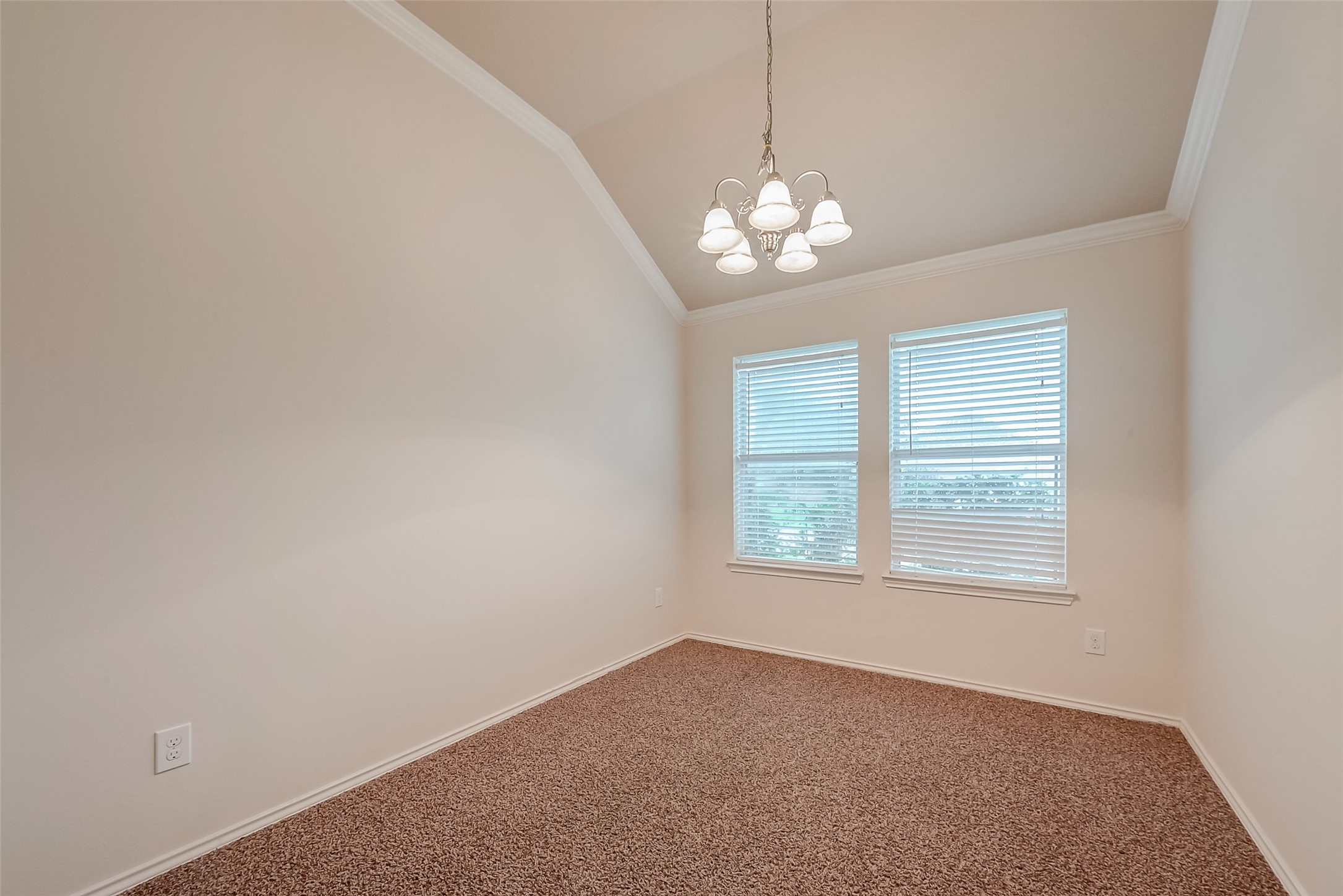 21203 Branchport Drive Houston, TX 77095 - Photo 13 of 49 an empty room with a chandelier fan and windows