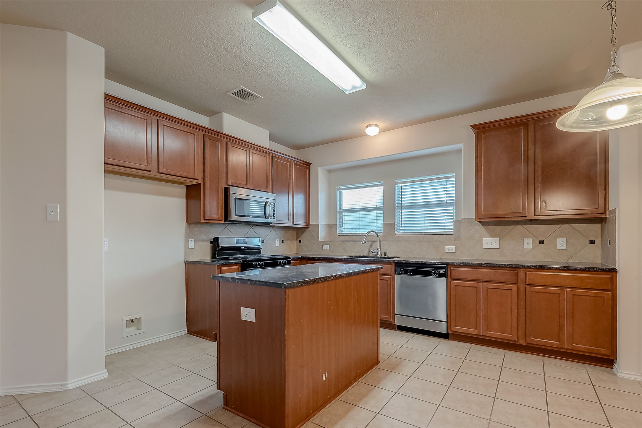 21203 Branchport Drive Houston, TX 77095 - Photo 19 of 49 a kitchen with stainless steel appliances granite countertop a sink stove and cabinets