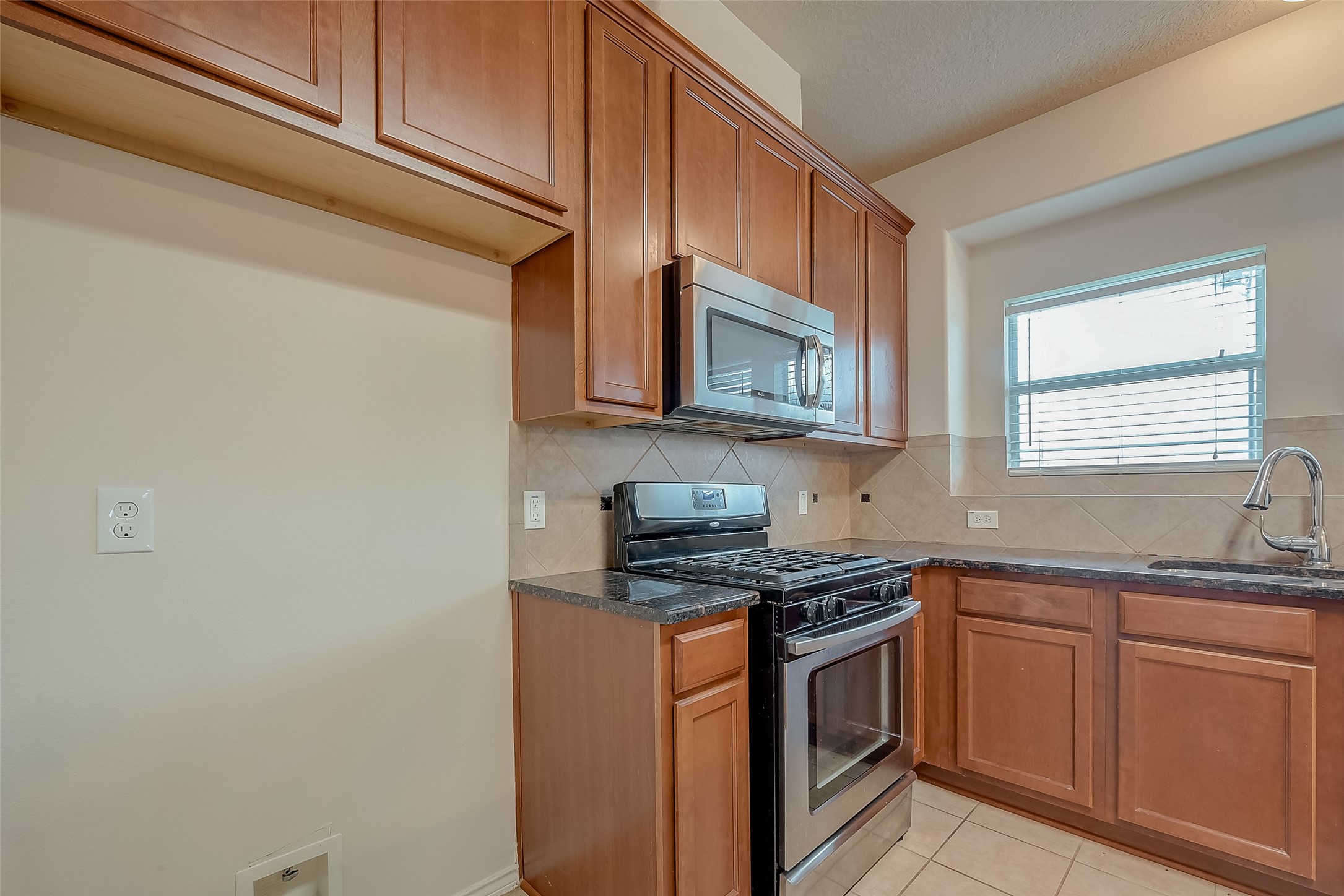 21203 Branchport Drive Houston, TX 77095 - Photo 20 of 49 a kitchen with stainless steel appliances granite countertop white cabinets a sink a stove and a microwave oven