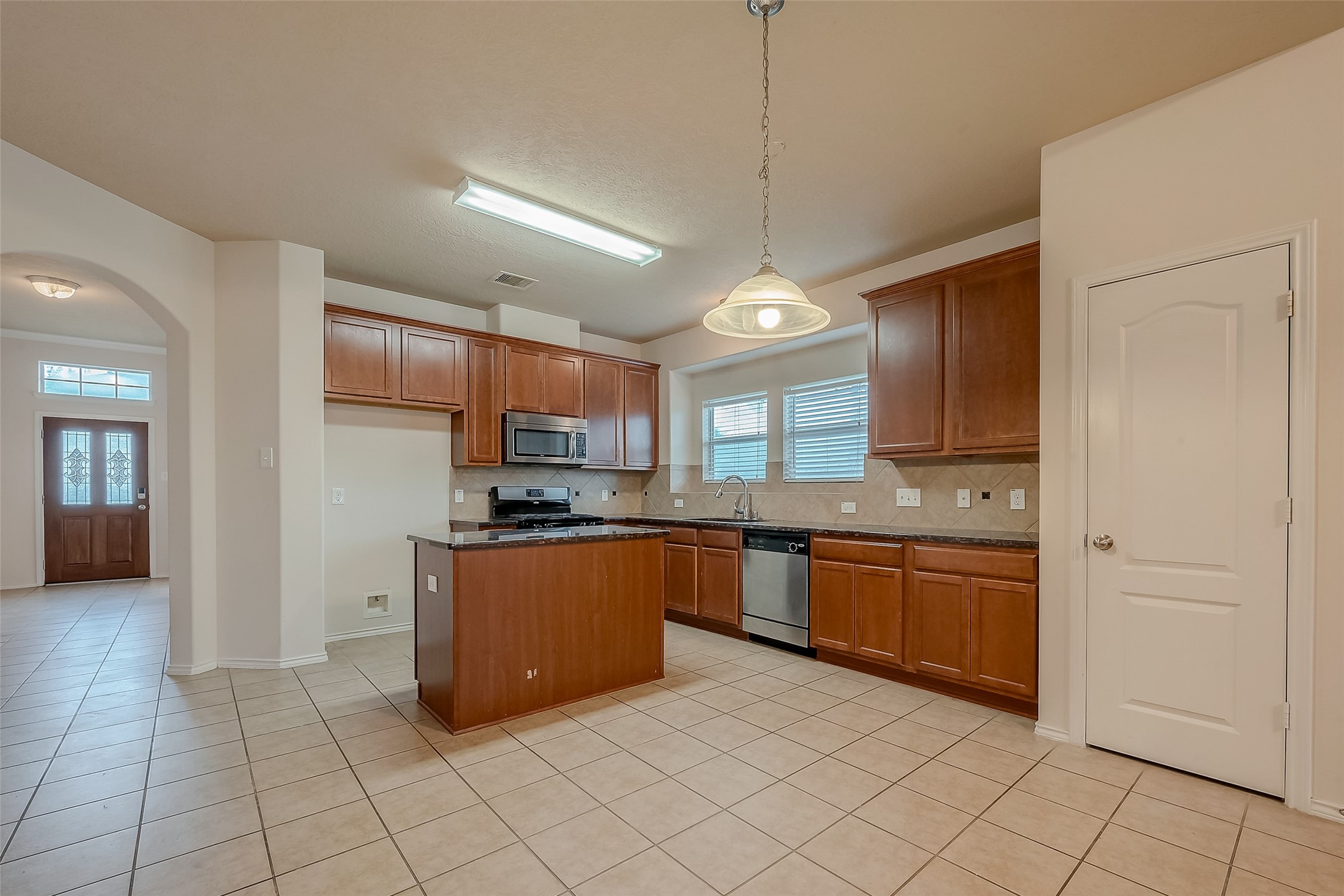 21203 Branchport Drive Houston, TX 77095 - Photo 23 of 49 a large kitchen with cabinets and stainless steel appliances