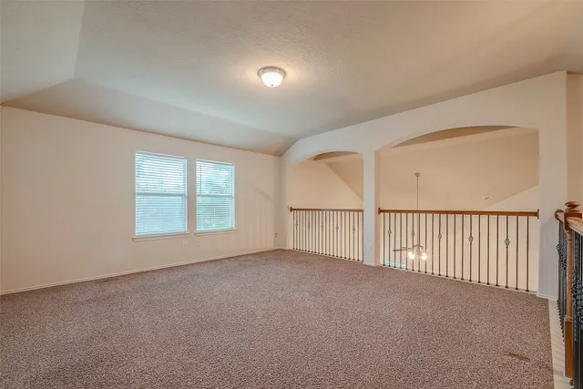 an empty room with a empty space and windows