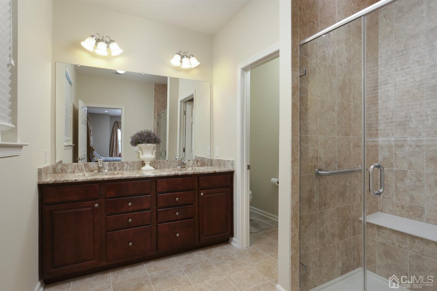 28 Harvest Ridge Road Howell, NJ 07731 - Photo 14 of 27 The Master bath has a double vanity, stall shower with seamless glass doors, and commode room.