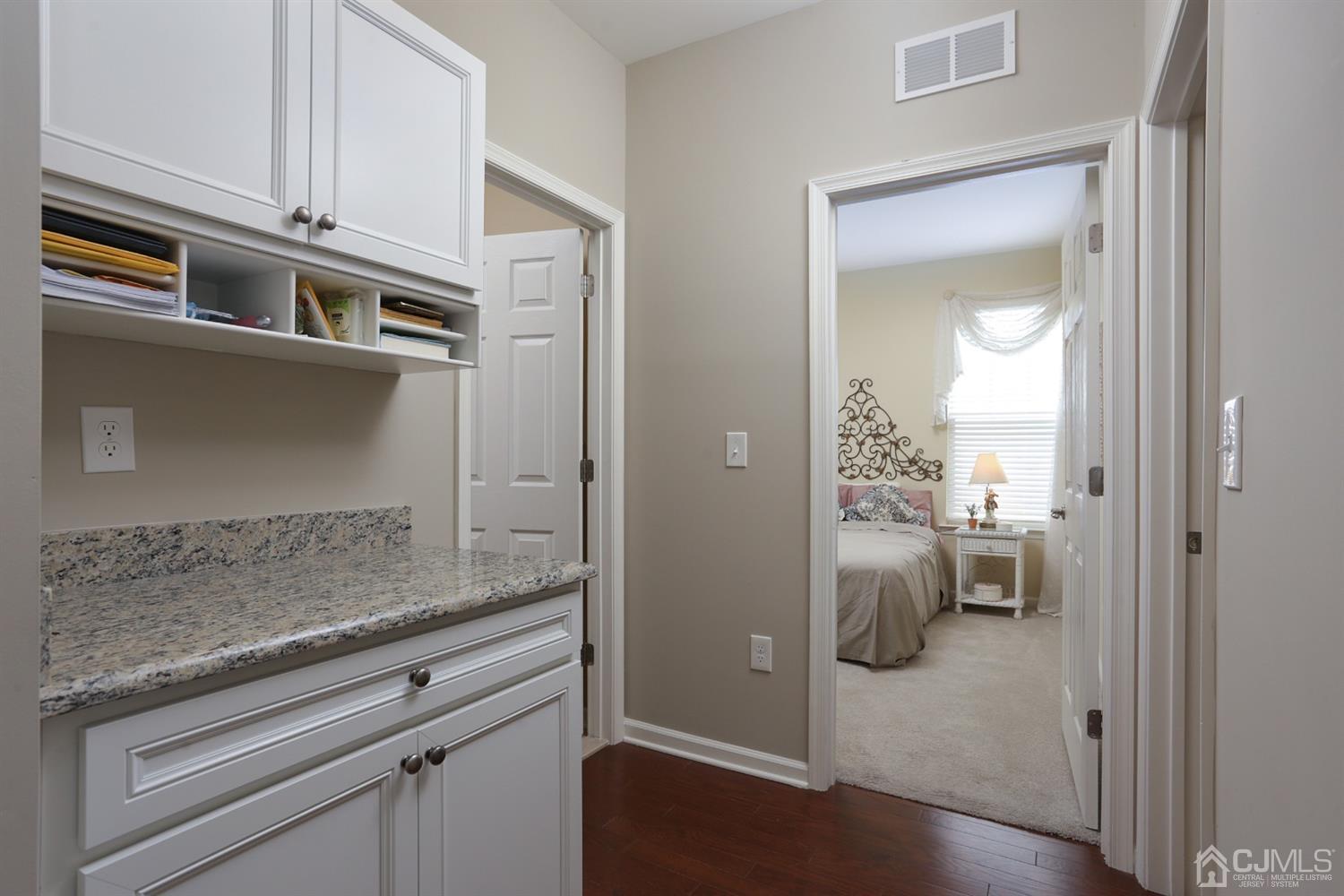 28 Harvest Ridge Road Howell, NJ 07731 - Photo 15 of 27 The hallway off the foyer leads to the second bedroom, second full bath, and laundry room.