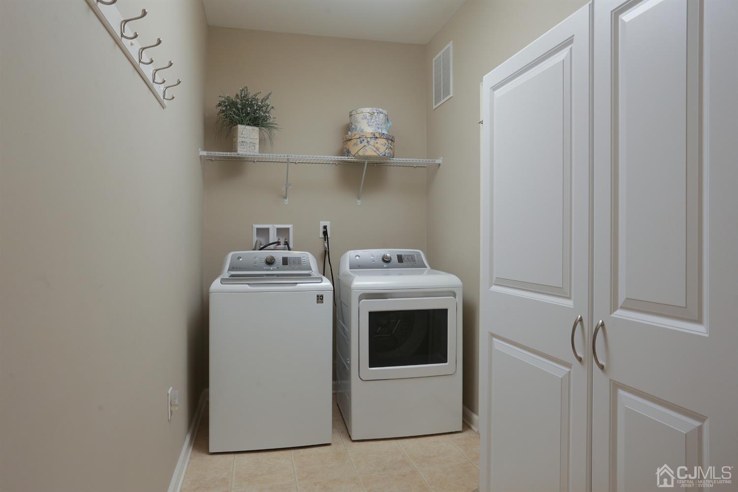 28 Harvest Ridge Road Howell, NJ 07731 - Photo 18 of 27 The laundry room has built in cabinetry with lots of storage.