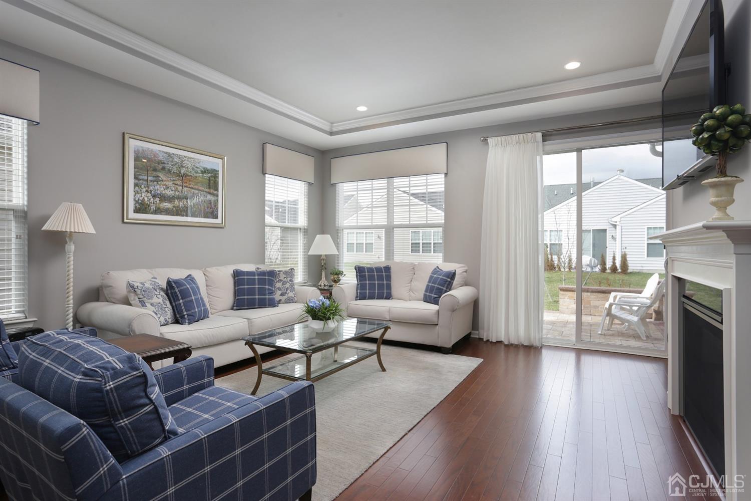28 Harvest Ridge Road Howell, NJ 07731 - Photo 5 of 27 The living area has hardwood floors and a beautiful gas fireplace. The side windows are an upgrade that let in a lot of extra light.