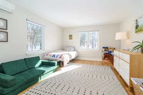 a bedroom with furniture and a window