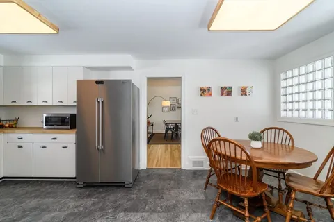 a view of kitchen with furniture and wooden floor