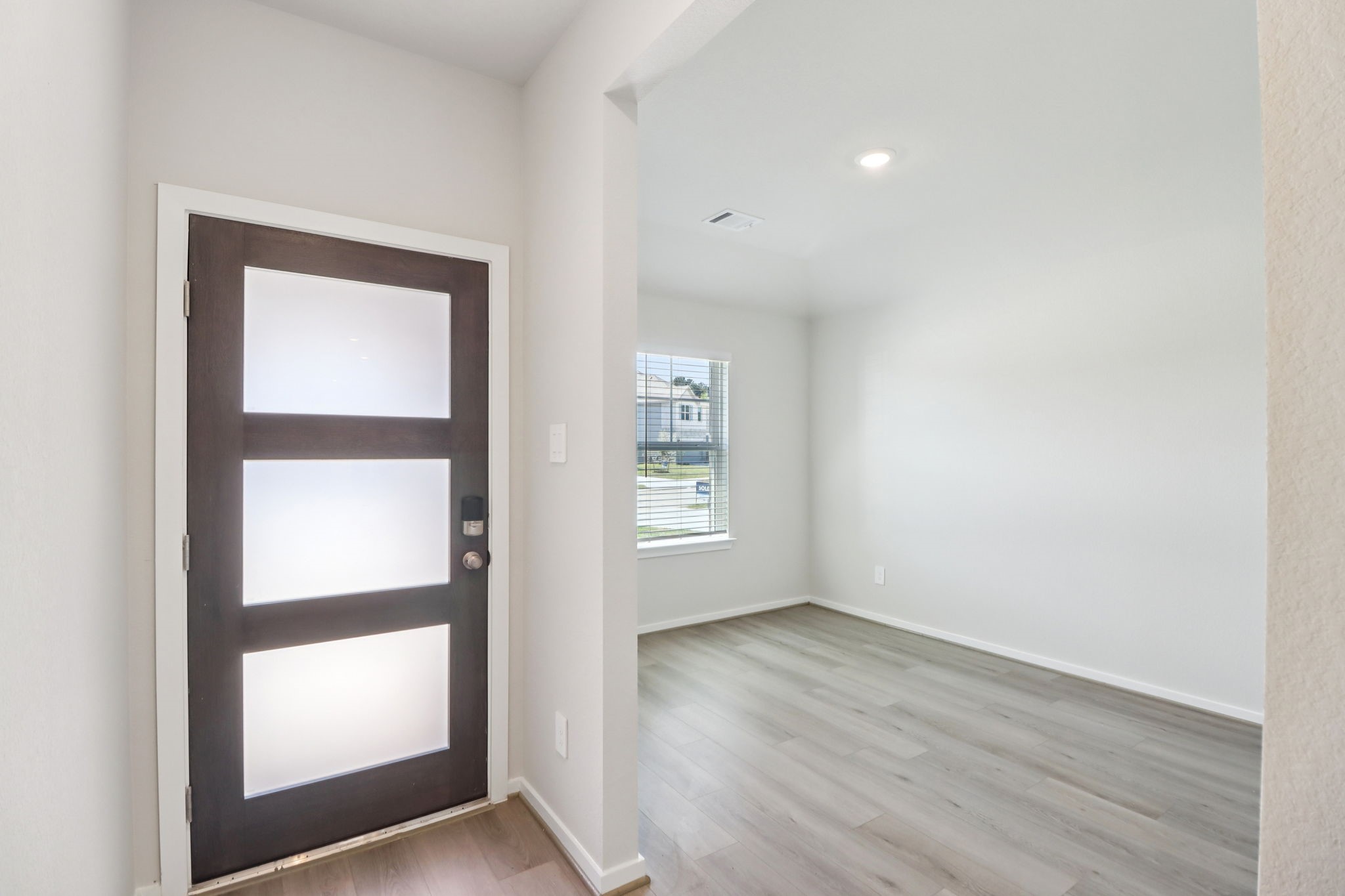 16273 Parish Pointe Court Conroe, TX 77302 - Photo 1 of 29 an empty room with wooden floor and windows