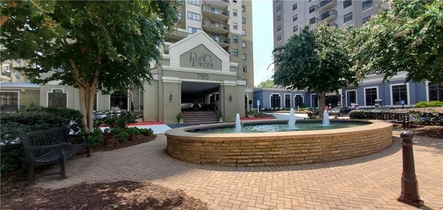 a view of a patio with couches and table with garden view