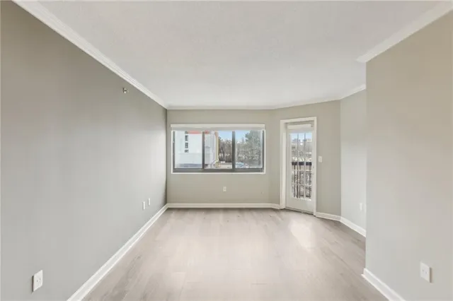 a view of an empty room with wooden floor