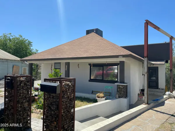 a front view of house with yard outdoor seating and barbeque oven