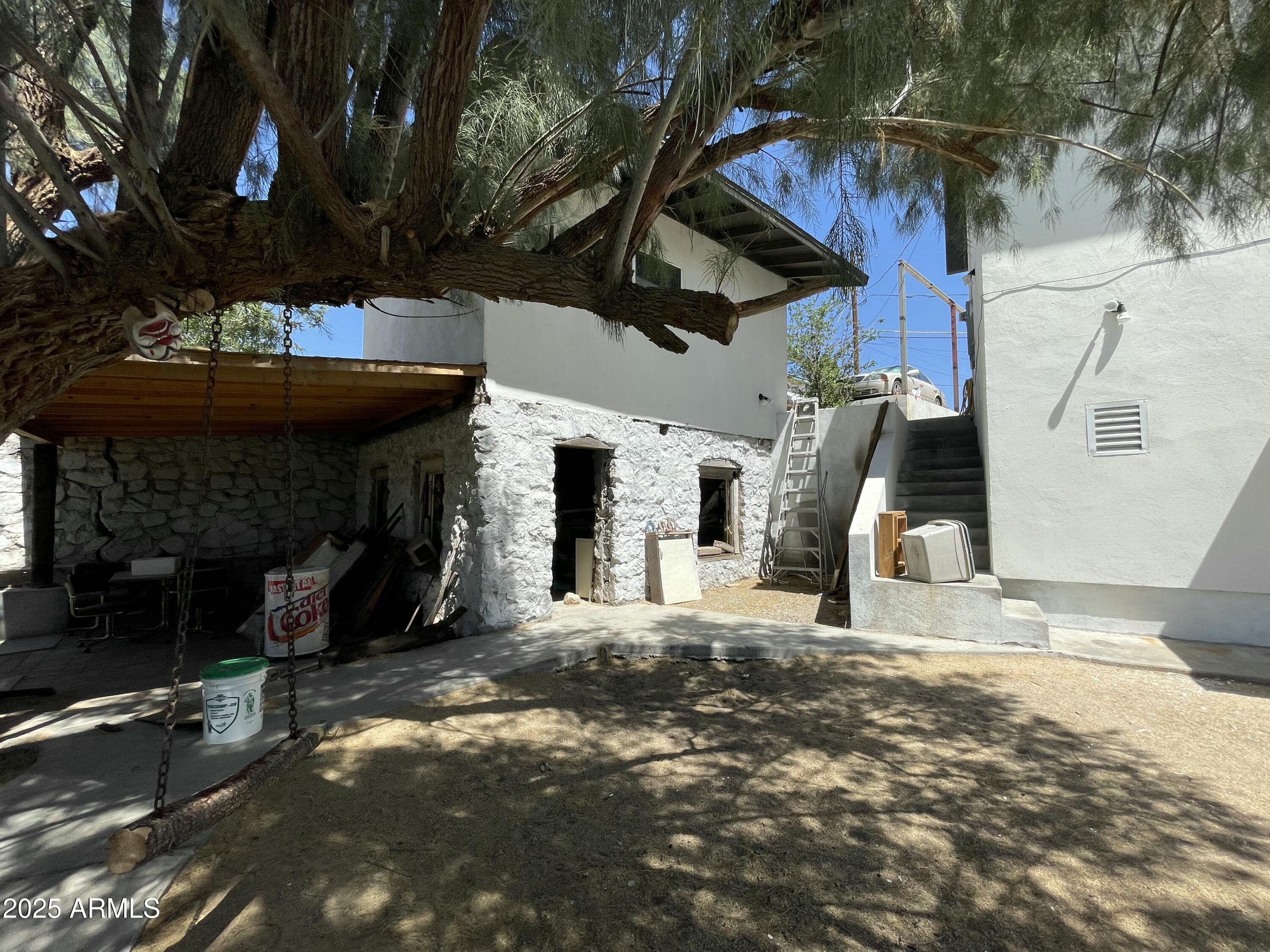 168 Cedar Avenue Miami, AZ 85539 - Photo 3 of 10 a view of a backyard with table and chairs with a fireplace and a fire pit