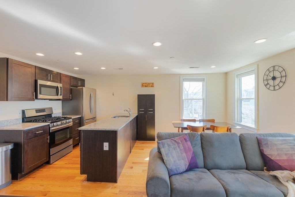 129 Spring Street, Unit 3 Cambridge, MA 02141 - Photo 5 of 17 a living room with stainless steel appliances granite countertop furniture and a window