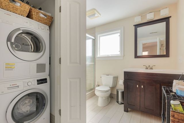 a bathroom with a toilet a sink and mirror