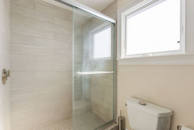 a bathroom with a shower and toilet