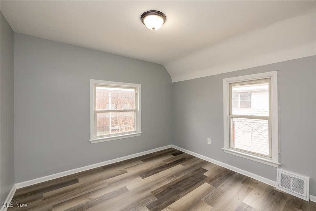 15328 Shiloh Road Cleveland, OH 44110 - Photo 3 of 27 Spare room with light wood-style flooring and lofted ceiling