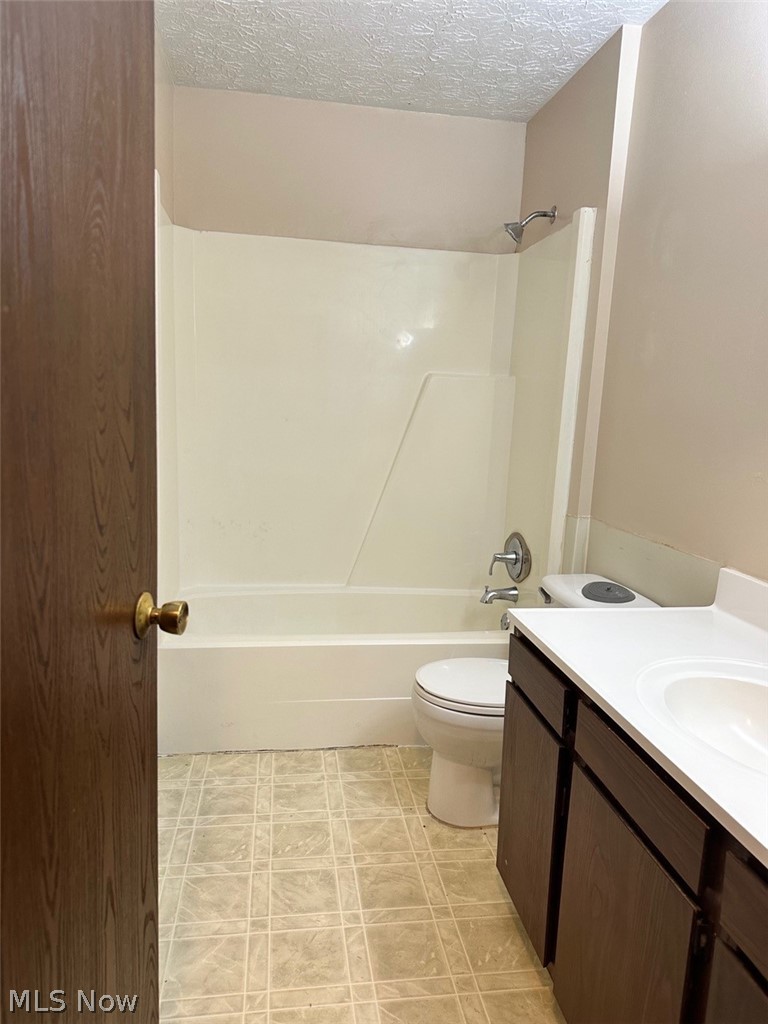 3102 Shaffer Road Atwater, OH 44201 - Photo 12 of 16 Full bathroom with shower / washtub combination, a textured ceiling, toilet, and vanity