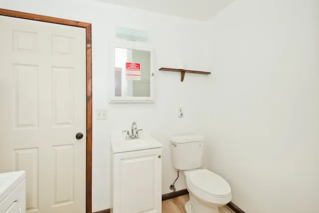 a white toilet sitting next to a bathroom sink