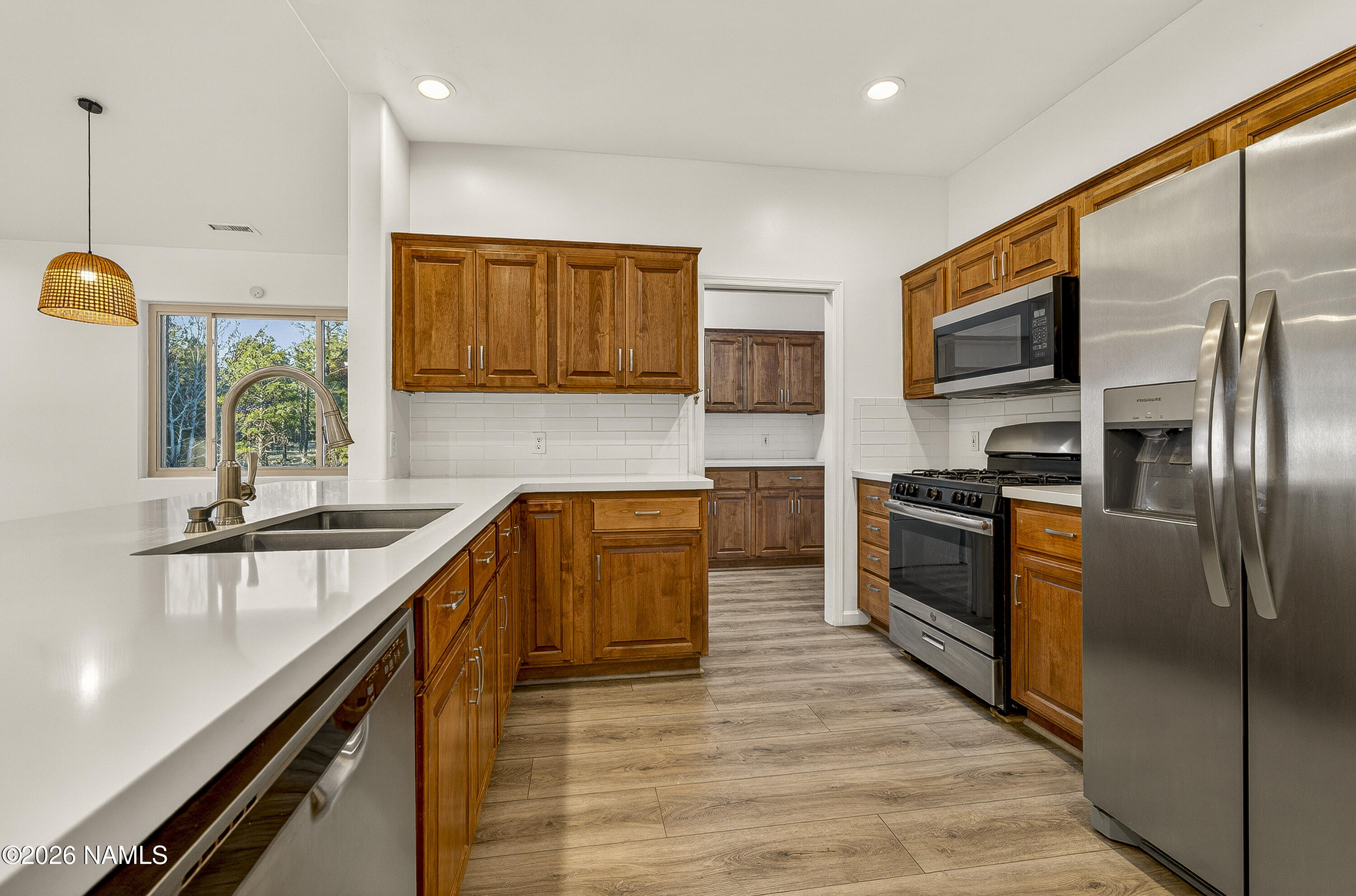 600 Brookline Loop Williams, AZ 86046 - Photo 11 of 43 a kitchen with stainless steel appliances granite countertop a refrigerator a sink a stove and oven